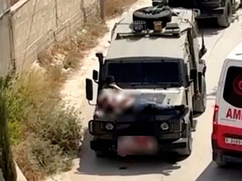 Israeli army straps Palestinian on military jeep during raid in Jenin,