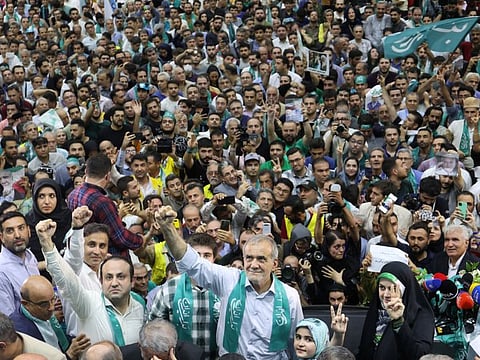 Iranian presidential candidate Masoud Pezeshkian waves during a campaign event in Tehran, on June 23, 2024.  