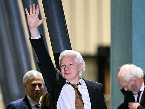 WikiLeaks founder Julian Assange (C) waves after arriving at Canberra Airport in Canberra.