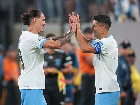  Uruguay forward Darwin Nunez handed over the captain's armband when Luis Suarez (right) brought in as a late substitute against Bolivia.