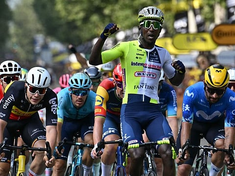 Intermarche - Wanty team's Eritrean rider Biniam Girmay cycles to the finish line ahead of second-placed Movistar Team's Colombian rider Fernando Gaviria (right) and third-placed Lotto Dstny team's Belgian rider Arnaud De Lie (L) to win the 3rd stage of the 111th edition of the Tour de France cycling race, 230,5 km between Piacenza and Turin, in Italy, on Monday.