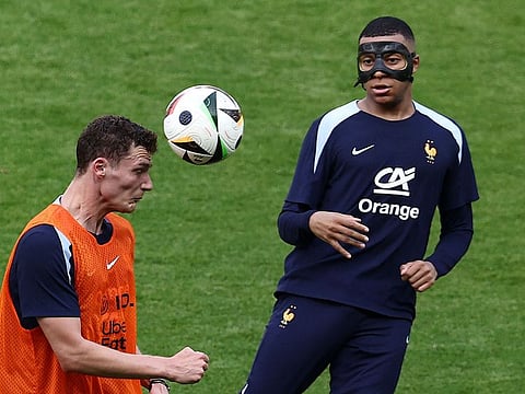 France's forward Kylian Mbappe wears a face mask during a training session at the Home Deluxe Arena Stadium in Paderborn, western Germany, on June 27.