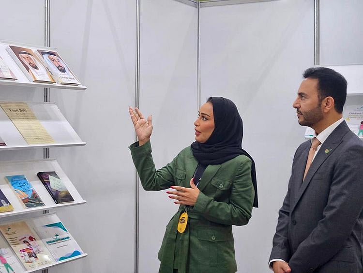 Abdulla-Saif-Al-Nuaimi,-Ambassador-of-the-UAE-to-the-Republic-of-Korea,-and-Khoula-Al-Mujaini,-Director-of-Events-and-Marketing-at-SBA-during-the-Ambassador's-visit-to-the-Sharjah-Book-Authority's-stand-1719919838236