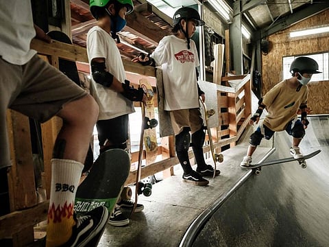 Children practice skateboarding at Hot Bowl Skate Park in Sapporo, Japan.