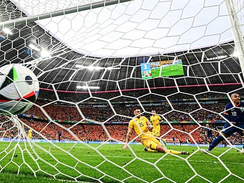 Netherlands' forward Donyell Malen (right) celebrates scoring his team's second goal during the Uefa Euro 2024 round of 16 football match against Romania at the Munich Football Arena in Munich on Tuesday.