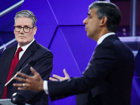 Britain's main opposition Labour Party leader Keir Starmer reacts as Britain's Prime Minister and Conservative Party leader Rishi Sunak speaks during a live TV debate, hosted by The BBC, in Nottingham, on June 26, 2024, in the build-up to the UK general election on July 4. 