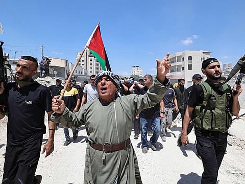 Mourners and gunmen carry the bodies of four Palestinians killed a day earlier in an Israeli airstrike on the Nur Shams refugee camp near Tulkarem in the occupied West Bank, during their funeral in the camp on July 3, 2024.  The Israeli government has seized a total of 23.7 square kilometres in the West Bank since the start of the year.
