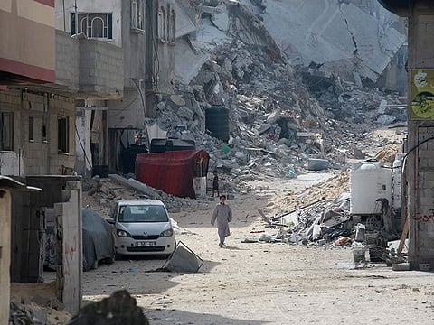 Palestinian children walk amid the destruction in a heavly damaged residential district of the southern Gaza Strip city of Khan Yunis on July 5, 2024, amid continuing battles between Hamas and Israel in the besieged territory. 