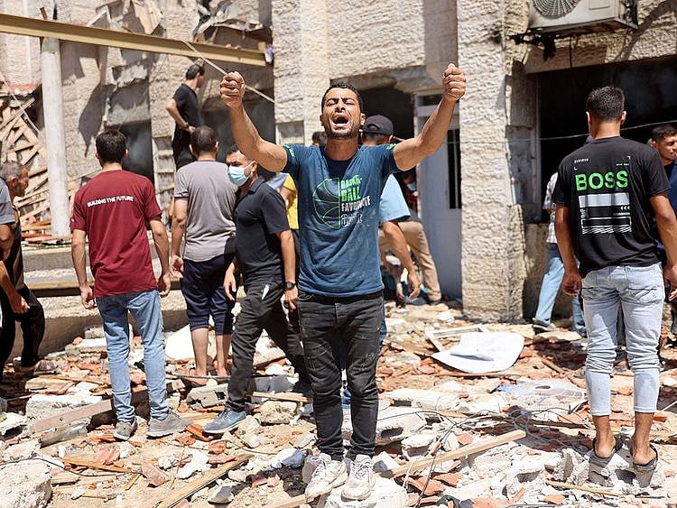 Palestinian rescuers search the rubble and debris of the Latin Patriarchate Holy Family School after it was hit during Israeli military bombardment, in Gaza City on July 7, 2024.