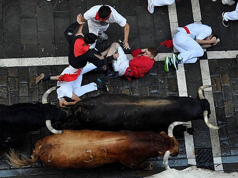 Participants run ahead of 'La Palmosilla' bulls during the "encierro" (bull-run) of the San Fermin festival in Pamplona.