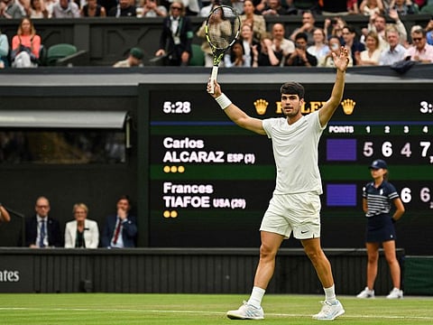 Spain's Carlos Alcaraz celebrates winning against US player Frances Tiafoe during their men's singles tennis match on the fifth day of the 2024 Wimbledon Championships at The All England Lawn Tennis and Croquet Club in Wimbledon.
