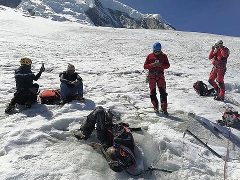 Handout picture released by Peruvian National Police shows police officers next to the body of US mountain climber William Stampfl, who was reported missing in June 2002, in the Ancash region, 400 km north of Lima.  