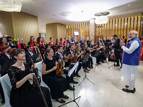 Prime Minister Narendra Modi applauds the Austrian orchestra for performing the ‘Vande Mataram’ on his arrival in Vienna, on Tuesday. 