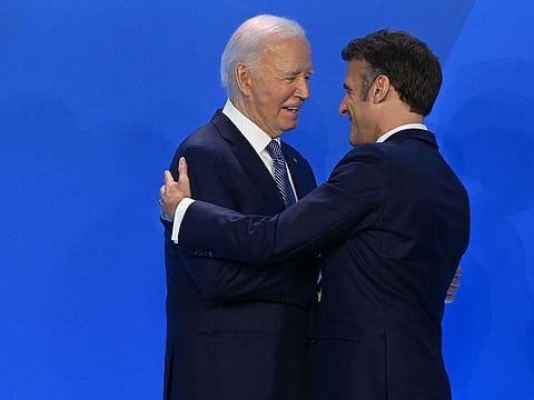 French President Emmanuel Macron is welcomed by US President Joe Biden as they attend the NATO 75th anniversary summit at the Walter E. Washington Convention Centre in Washington, DC, on July 9, 2024. 