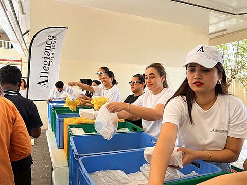 Allegiance volunteers distributing food and water to workers.