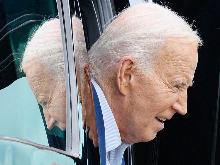 US President Joe Biden steps out of his motorcade 