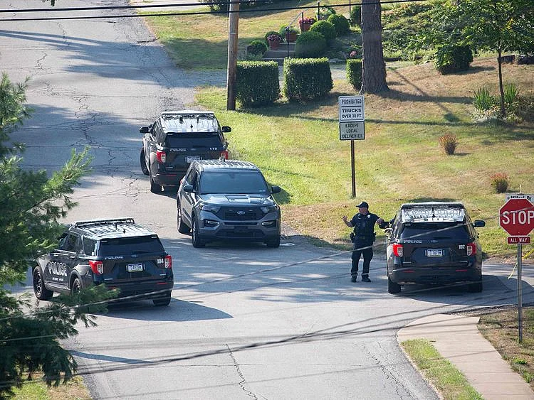 Local police block off roads surrounding the home of the suspected shooter of Trump, as the FBI carries out an investigation, in Bethel Park, Pennsylvania, on July 14, 2024.  The alleged shooter was killed by law enforcement officials after he fired an AR-15-type semiautomatic rifle, killing one spectator and wounding others.