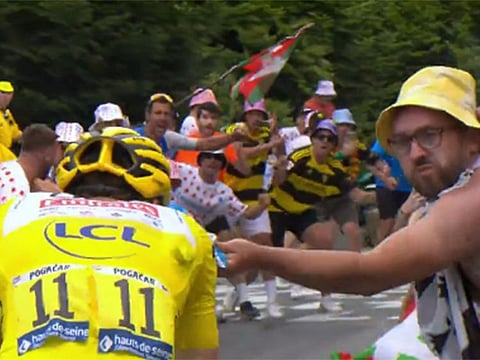The bare-torsoed spectator appeared to toss the potato chips into the faces of the riders.