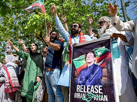Supporters of Pakistan's former prime minister and Pakistan Tehreek-e-Insaaf (PTI) party leader Imran Khan, celebrate after a court verdict overturned his illegal marriage conviction, outside the court building in Islamabad on July 13, 2024.  