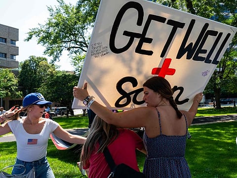 People attend a prayer vigil and voter registration event for former president Donald Trump in the downtown area before the start of the Republican National Convention (RNC) on July 14, 2024 in Milwaukee, Wisconsin.  