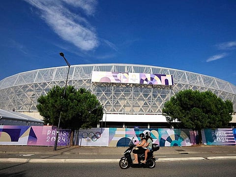 A motorbike rides past the Nice Stadium, where some of the Olympic football matches, part of the Paris 2024 Olympic Games will be played, in the southern Mediterranean city of Nice on July 17, 2024. 