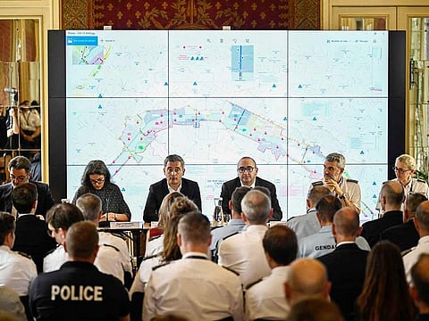 France's Minister for Interior and Overseas Gerald Darmanin (Centre-L) flanked by Prefect of Police of Paris Laurent Nunez (Centre-R), speaks during a meeting regarding the activation of the anti-terrorist perimeter (SILT) starting July 18, 2024, at the Police Prefecture on the Ile de la Cite, in Paris, on July 17, 2024, ahead of the Paris 2024 Olympic and Paralympic Games.  