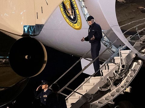 US President Joe Biden gestures as he steps off of Air Force One upon arrival at Dover Air Force Base in Dover, Delaware.