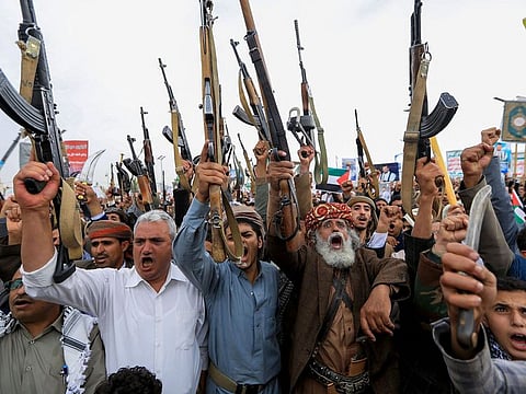  Yemenis brandish rifles during a rally in the Houthi-controlled capital Sana'a in solidarity with Palestinians on July 19, 2024.