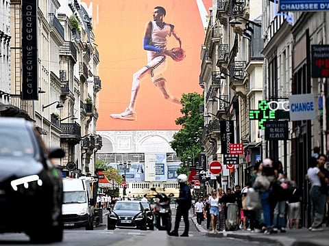 An advertising banner depicts France's basketball player Victor Wembanyama on a street ahead of the Paris 2024 Olympic on Sunday.