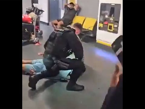 The video appeared to show a police officer kicking and stamping on the head of a men lying on the ground, next to a woman.