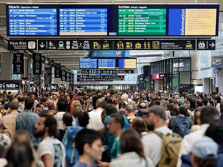  Passengers gather around the departure boards at the Gare Montparnasse train station in Paris 