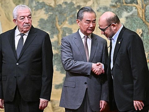 (L-R) Mahmoud al-Aloul, Vice Chairman of the Central Committee of Palestinian organization and political party Fatah, China's Foreign Minister Wang Yi, and Mussa Abu Marzuk, senior member of the Palestinian Islamist movement Hamas, attend an event at the Diaoyutai State Guesthouse in Beijing on July 23, 2024