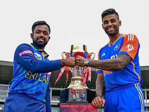 Sri Lankan captain Charith Asalanka (left) and his Indian counterpart Suryakumar Yadav hold the Twenty20 trophy after the press conference in Pallekele on Friday. 