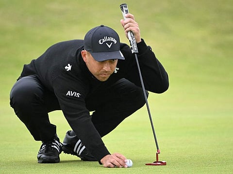 US golfer Xander Schauffele places his ball on the 15th green during his final round,  on day four of the 152nd British Open Golf Championship at Royal Troon on the south west coast of Scotland on July 21.