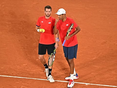 US' Austin Krajicek (left) and US' Rajeev Ram speak during their match against Spain's Rafael Nadal and Spain's Carlos Alcaraz in the men's doubles quarter-final tennis on Wednesday.