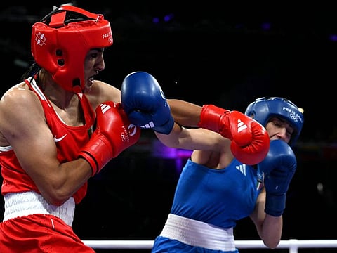 Algeria's Imane Khelif (in red) punches Italy's Angela Carini in the women's 66kg preliminaries round of 16 boxing match during the Paris 2024 Olympic Games at the North Paris Arena, in Villepinte on August 1, 2024. (Photo by MOHD RASFAN / AFP)