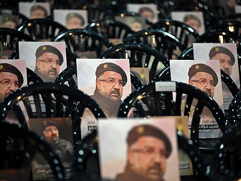Portraits of slain Hezbollah commander Fuad Shukr are placed on chairs ahead of his funeral in the southern suburbs of the Lebanese capital Beirut on August 1, 2024. Hezbollah on August 1, mourned its top commander Shukr, whose body was recovered from the rubble of an Israeli strike in south Beirut on July 30, as fears mounted of a wider conflict.  