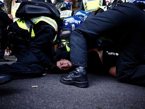 Police officers detain a protestor during the 'Enough is Enough' demonstration on Whitehall, outside the entrance to 10 Downing Street in central London on July 31, 2024, held in reaction the Government's response to the fatal stabbings in Southport on July 29.  