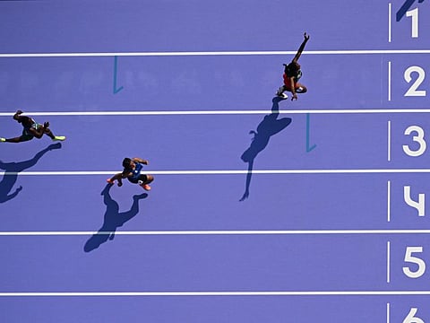 Solomon Islands' Sharon Firisua (left) competes in the women's 100m heat at the Paris 2024 Olympic Games at Stade de France on Friday.