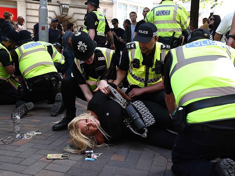 Protesters are detained in Nottingham, central England, on August 3, 2024 during the ‘Enough is Enough’ demonstration held in reaction to the fatal stabbings in Southport on July 29.