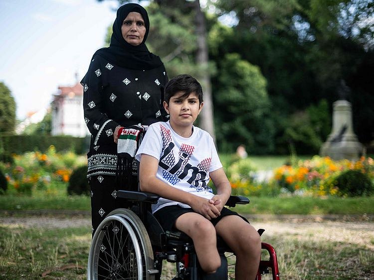 Raja Abdulkareem Abu Mhadi, 47-year-old Palestinian from Gaza and her son Asef, 12, amputated after a bombardment pose in Vincennes, on the outskirts of Paris, on July 19, 2024. Asef is one of the 15 children that French authorities has agreed to provide care in France, out of the 300 or so Palestinians that France has been able to bring out of Gaza.  
