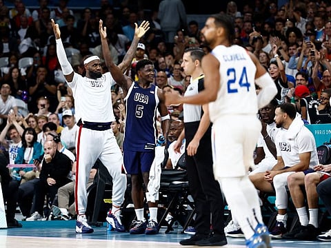 USA's LeBron James (left) and Anthony Edwards cheer on in the last seconds of the men's preliminary round group C basketball match against Puerto Rico.