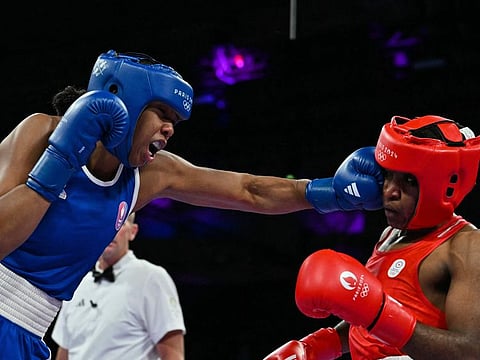 Refugee Olympic Team's Cindy Winner Djankeu Ngamba and France's Davina Michel (Blue) compete in the women's 75kg quarter-final boxing match during the Paris 2024 Olympic Games at the North Paris Arena, in Villepinte on Sunday.