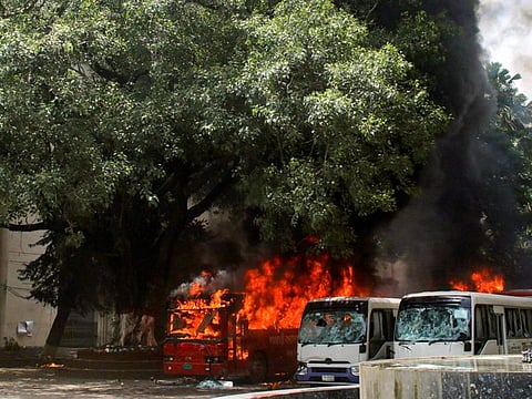 Buses on fire at the Bangabandhu Sheikh Mujib Medical University premises after a clash between students and government supporters in Dhaka on August 4, 2024.