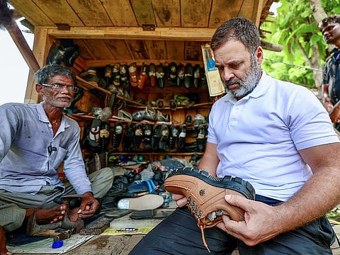 Congress leader Rahul Gandhi meets with a skilled cobbler in India