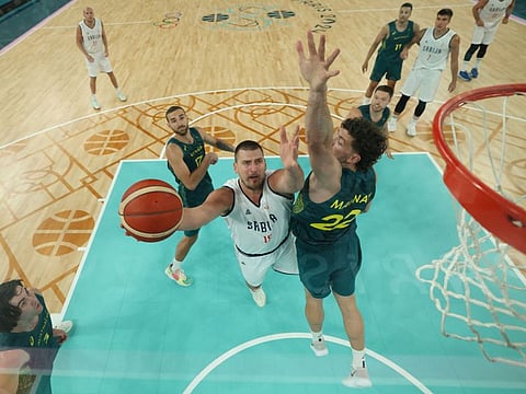 Serbia's Nikola Jokic goes to the basket past Australia's Will Magnay in the men's quarter-final basketball match during the Paris 2024 Olympic Games at the Bercy  Arena in Paris on Tuesday.