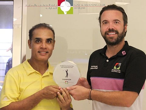 Amiya Ranjan (L) receives the trophy