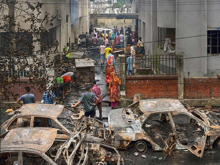 Damaged vehicles following a protest in Dhaka
