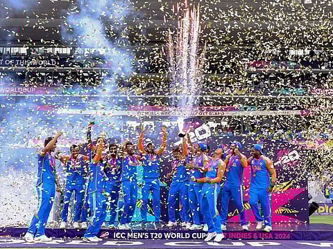 India's players celebrate with the trophy after beating South Africa by 7 runs in the ICC Mens T20 World Cup 2024 final match, at Kensington Oval in Barbados 