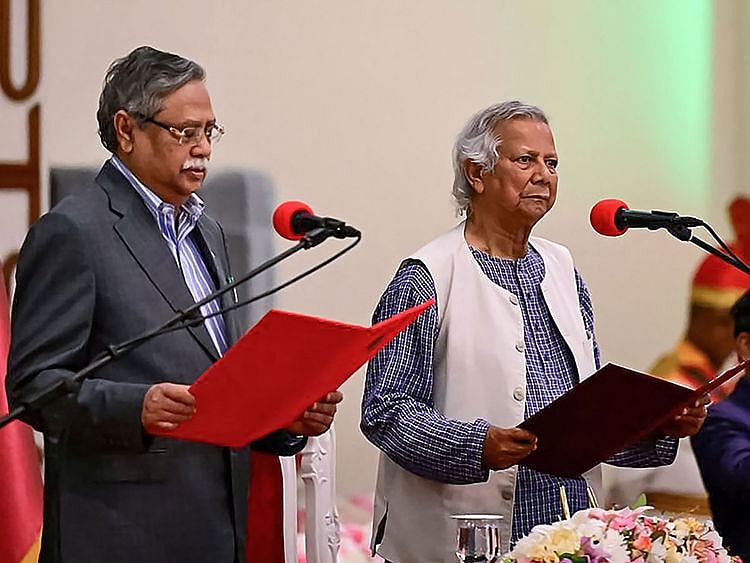 Nobel laureate Muhammad Yunus (right) takes the oath of office as the chief adviser of Bangladesh's new interim government during the oath-taking ceremony administered by President Mohammed Shahabuddin in Dhaka on August 8, 2024.  